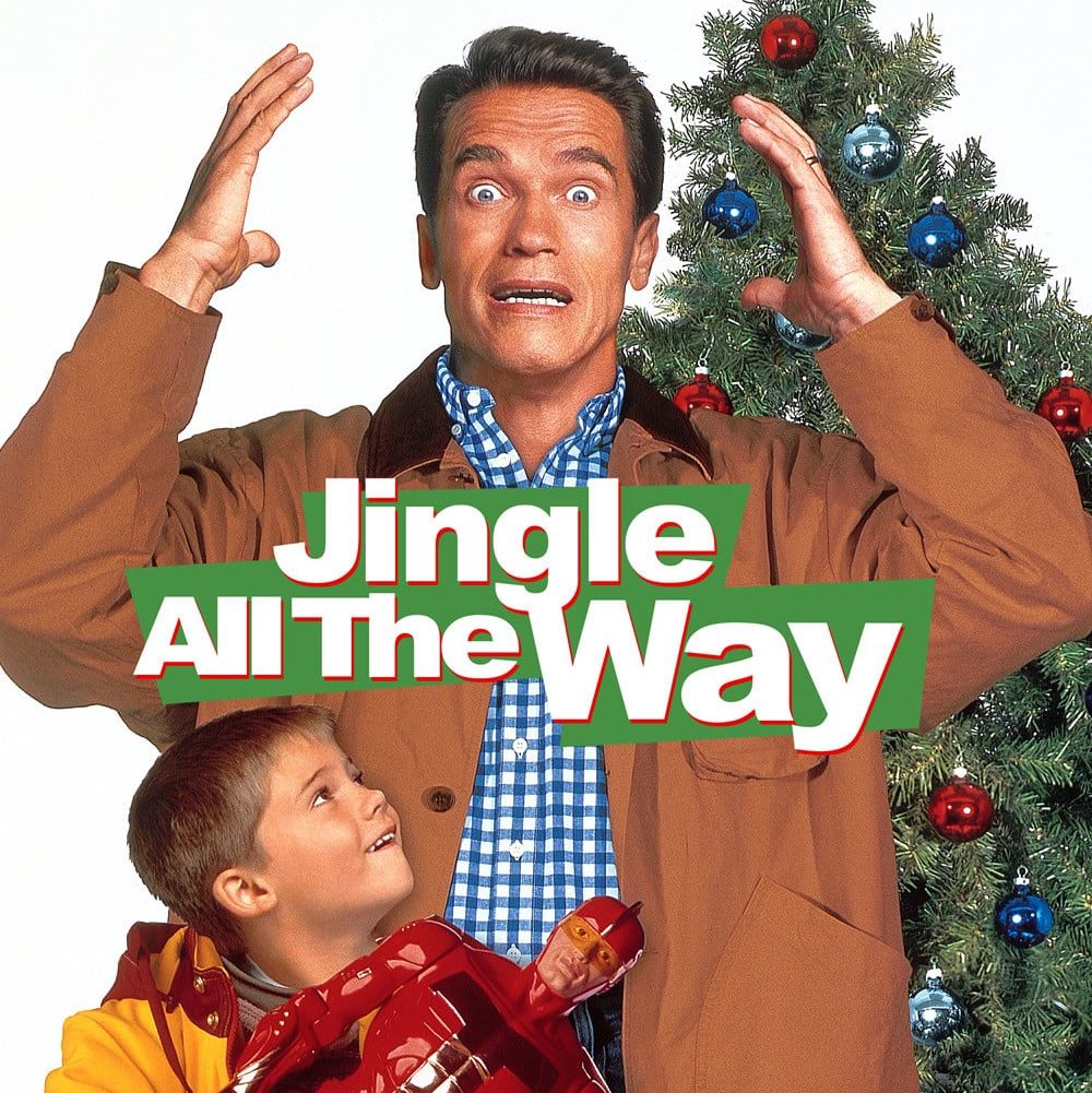 Motorworks Brewing presents Jingle All The Way Movie Poster with Arnold Schwarzenegger in front of Christmas tree and young boy standing in front looking up at him