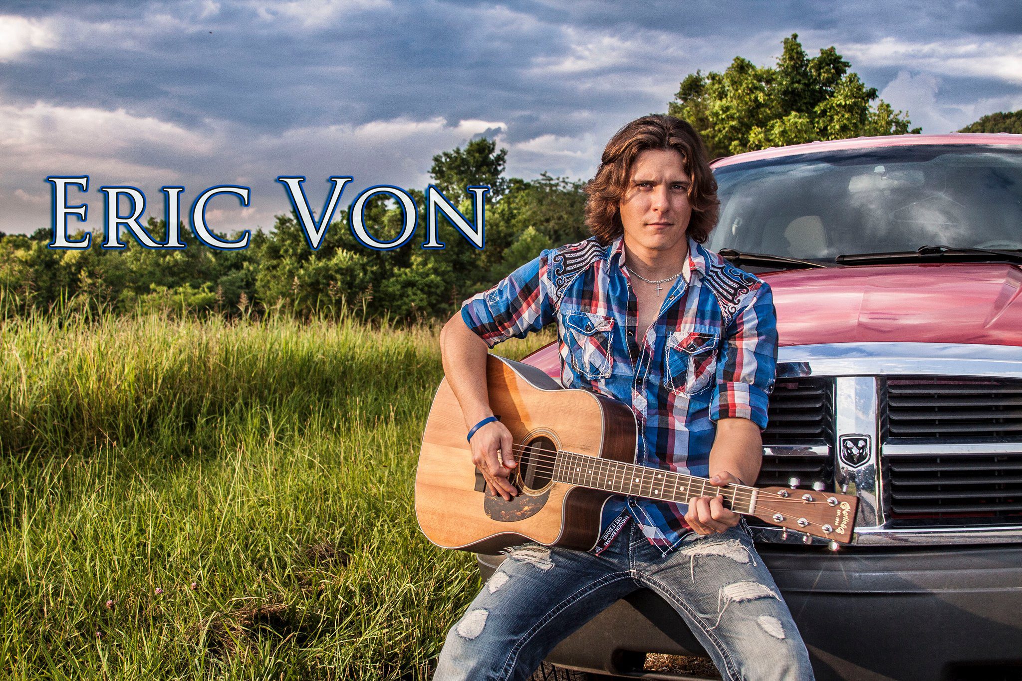Motorworks Brewing presents Eric Von performer with guitar in the country sitting on a truck bumper