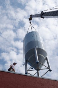 Motorworks Brewing Fermenter in sky going into building.