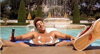 Motorworks Brewing presents Billy Madison movie cover with Adam Sandler in the swimming pool and sunscreen drawn in a smile on his torso