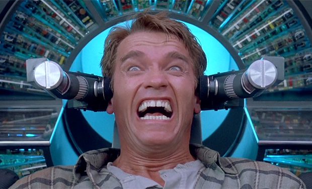 Motorworks Brewing presents Total Recall movie cover with Arnold Schwarzenegger screaming on chair in front of futuristic technology