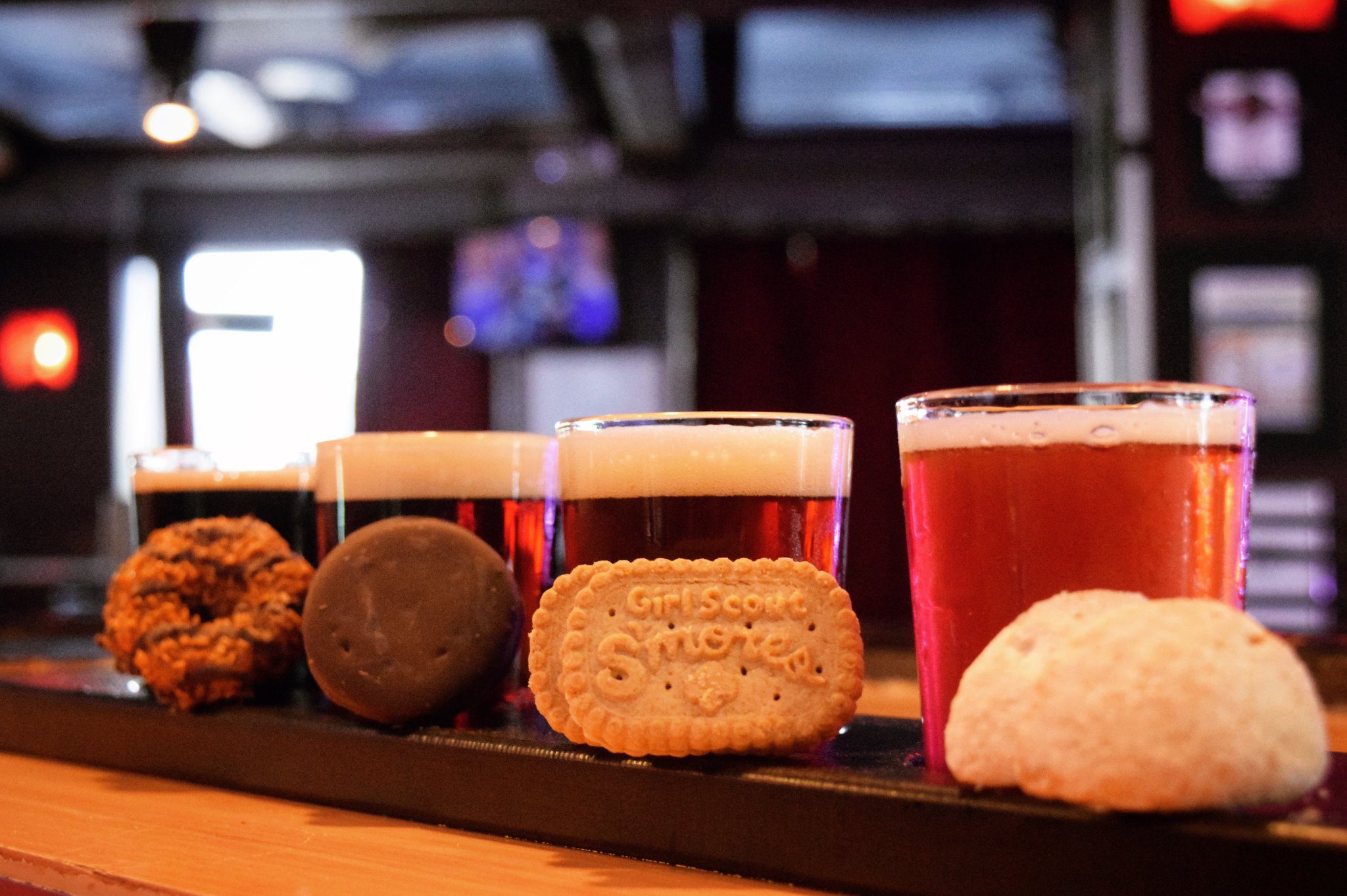 Motorworks Brewing Cookies & Crafts flight with 4 different tasting beers paired with 4 different girl scout cookies next to the appropriate beer in taproom