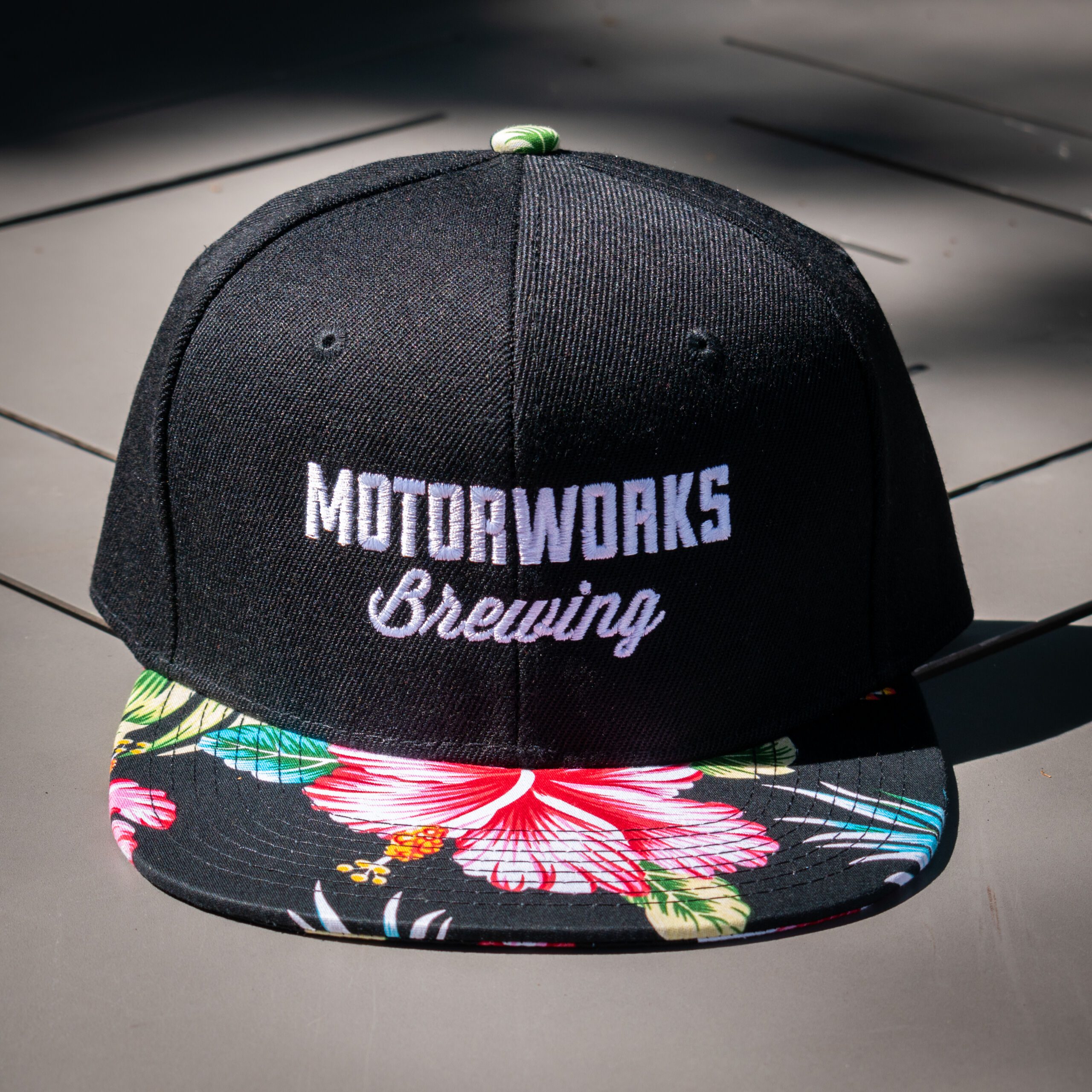 https://motorworksbrewing.com/wp-content/uploads/2023/05/Logo-Snapback-Black-Tropical-0009-scaled.jpg