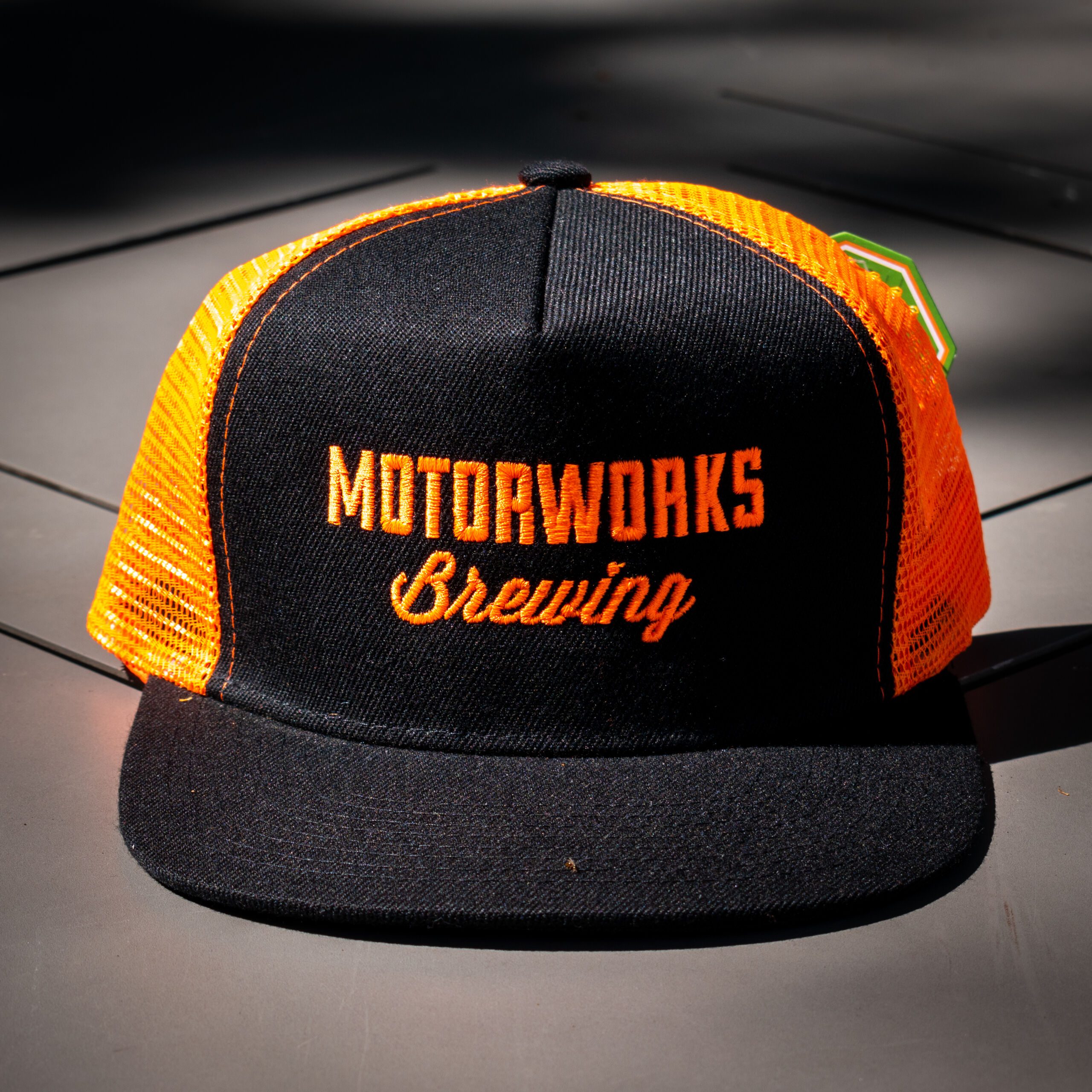 https://motorworksbrewing.com/wp-content/uploads/2023/05/Logo-Trucker-Black-Orange-0012-scaled.jpg